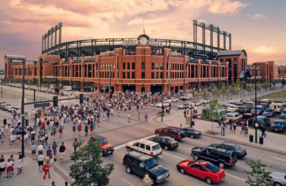 AD37R9 Crowds stream into Coors Field, home of the Colorado Rockies baseball team, at sunset in Denver, Colorado, USA.