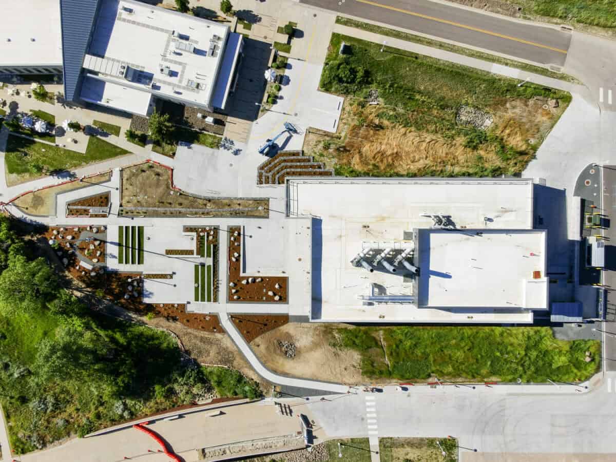 July 16, 2023 - The Research and Innovation Laboratory (RAIL), on the National Renewable Energy Laboratory’s (NREL’s) South Table Mountain (STM) campus, is a flexible, multipurpose lab space to support growing cross-disciplinary research. Aerial view of the RAIL looking down on roof and landscape features. (Photo by Joshua Bauer and Bryan Bechtold / NREL)