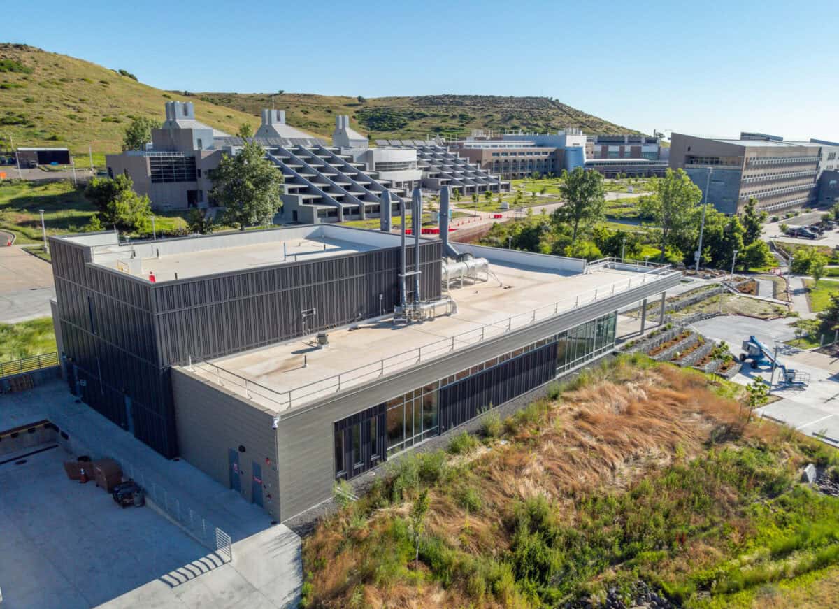 July 16, 2023 - The Research and Innovation Laboratory (RAIL), on the National Renewable Energy Laboratory’s (NREL’s) South Table Mountain (STM) campus, is a flexible, multipurpose lab space to support growing cross-disciplinary research. Aerial view of the RAIL (left) looking northeast toward the heart of the campus. (Photo by Joshua Bauer and Bryan Bechtold / NREL)